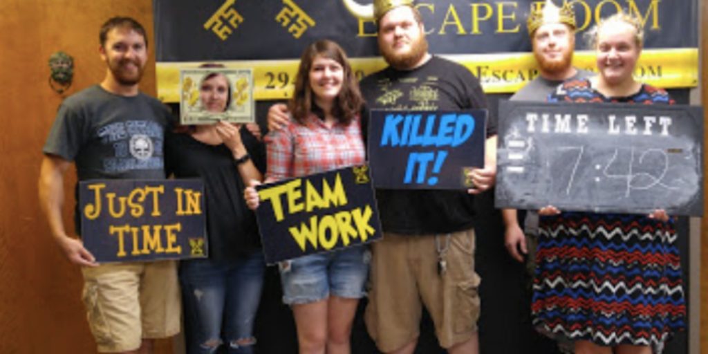 group of people that just managed to escape the room at Amazing Escape